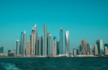A buyer reviewing the steps of the Dubai property purchase process with documents, a checklist, and a cityscape in the background