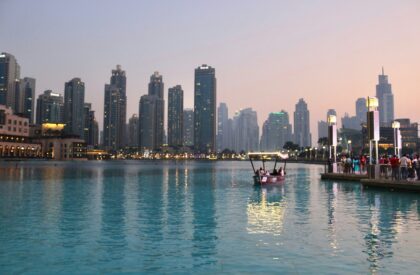 A real estate expert analyzing market data and trends on a screen, with Dubai’s skyline in the background