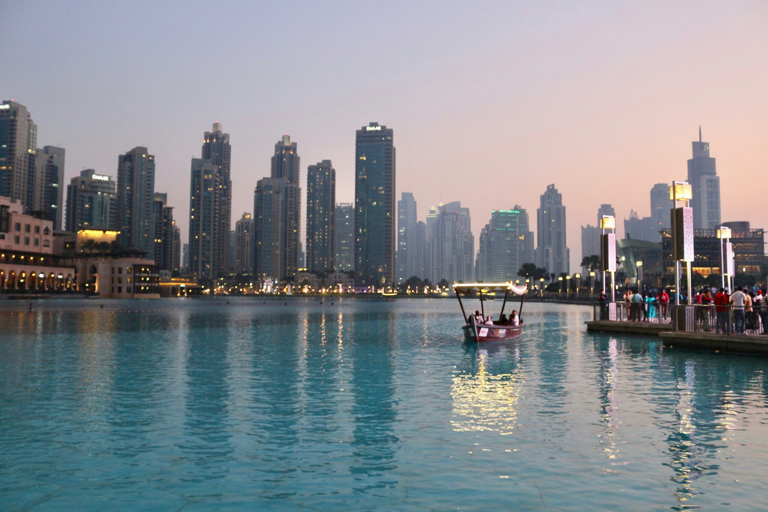 A real estate expert analyzing market data and trends on a screen, with Dubai’s skyline in the background