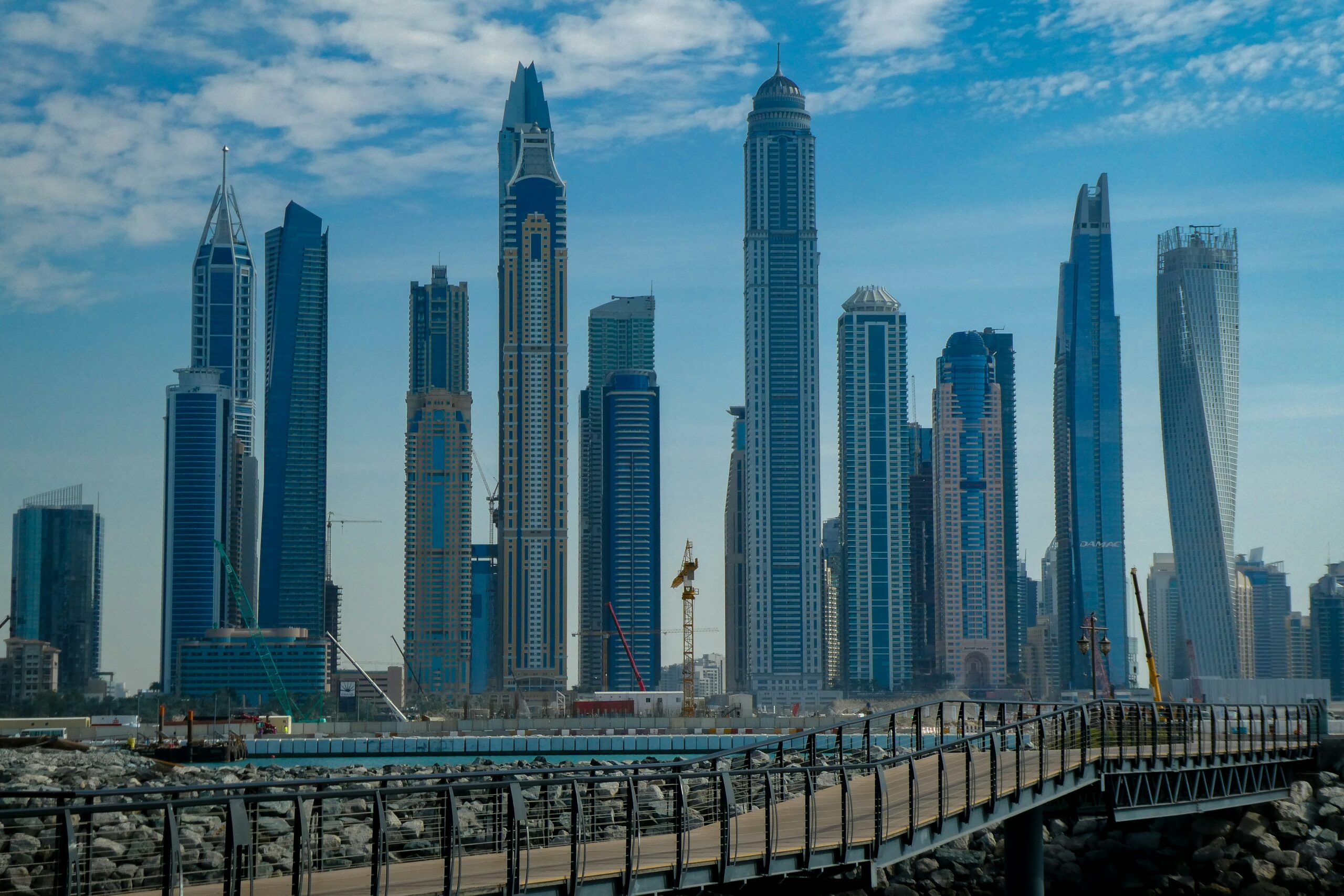 A map of Dubai highlighting the top 5 emerging investment areas for 2025, with visuals of new developments and properties