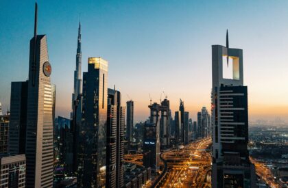 Analyzing Dubai Property Pricing – Economic Factors Behind Real Estate Values A real estate analyst examining graphs and charts showcasing Dubai property pricing trends and economic factors