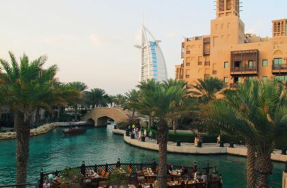 Securing a Mortgage in Dubai – Expert Tips for Expat Homebuyers An expat couple discussing mortgage options with a financial advisor in Dubai, with documents and property listings on the table