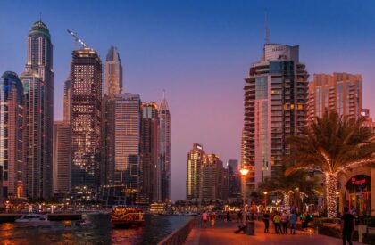 A real estate investor analyzing Dubai’s property market trends with a city skyline and financial charts.