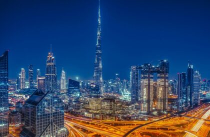 Dubai skyline at night with Burj Khalifa, illuminated cityscape, and highways