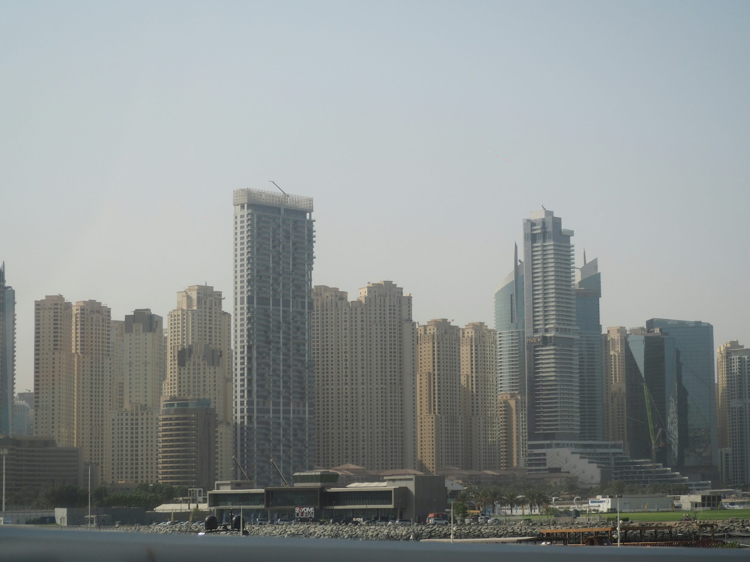 A lawyer reviewing property documents for a foreign investor in Dubai, with legal guidelines and UAE regulations in focus.