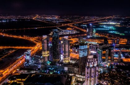 Close-up of a real estate financing document with a calculator and pen, illustrating the financial aspects of property investment in Dubai.