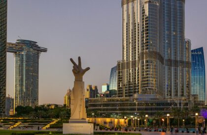 How Global Economic Trends Affect Dubai Real Estate – A 2025 Market Outlook Graphic showing global economic indicators with Dubai skyline in the background, representing how international trends influence the real estate market in Dubai.