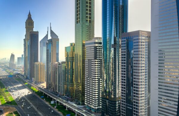 First-time property buyer exploring real estate options in Dubai with guidance from an agent and property listings in hand.